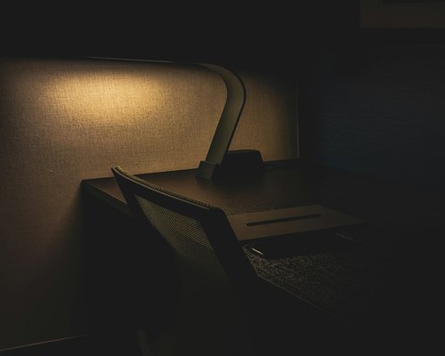 A modern desk lamp emitting soft warm light