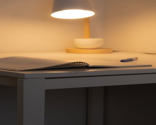 Reading a book with warm desk lamp lighting at night